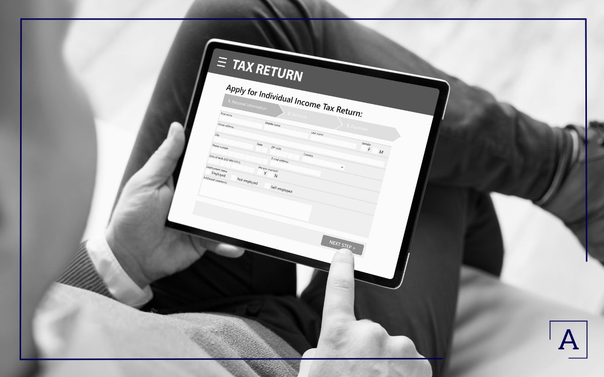 Person using a tablet to complete a DIY tax return online, filling out individual income tax form on a digital device.